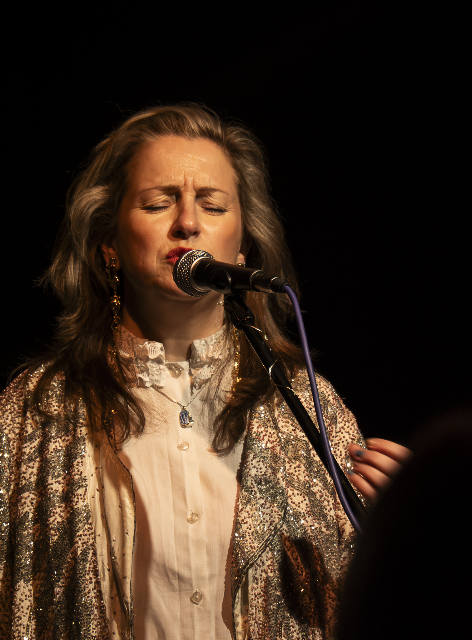 Maggie May Treanor performing live in gold sequined jacket